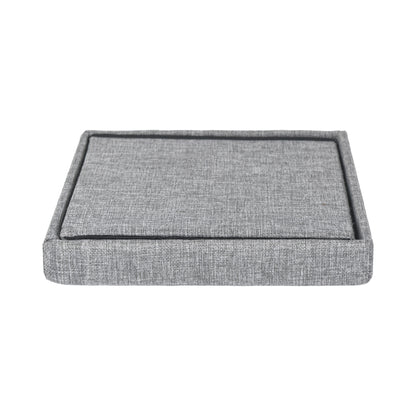 Grey linen square ottoman showing folded storage position